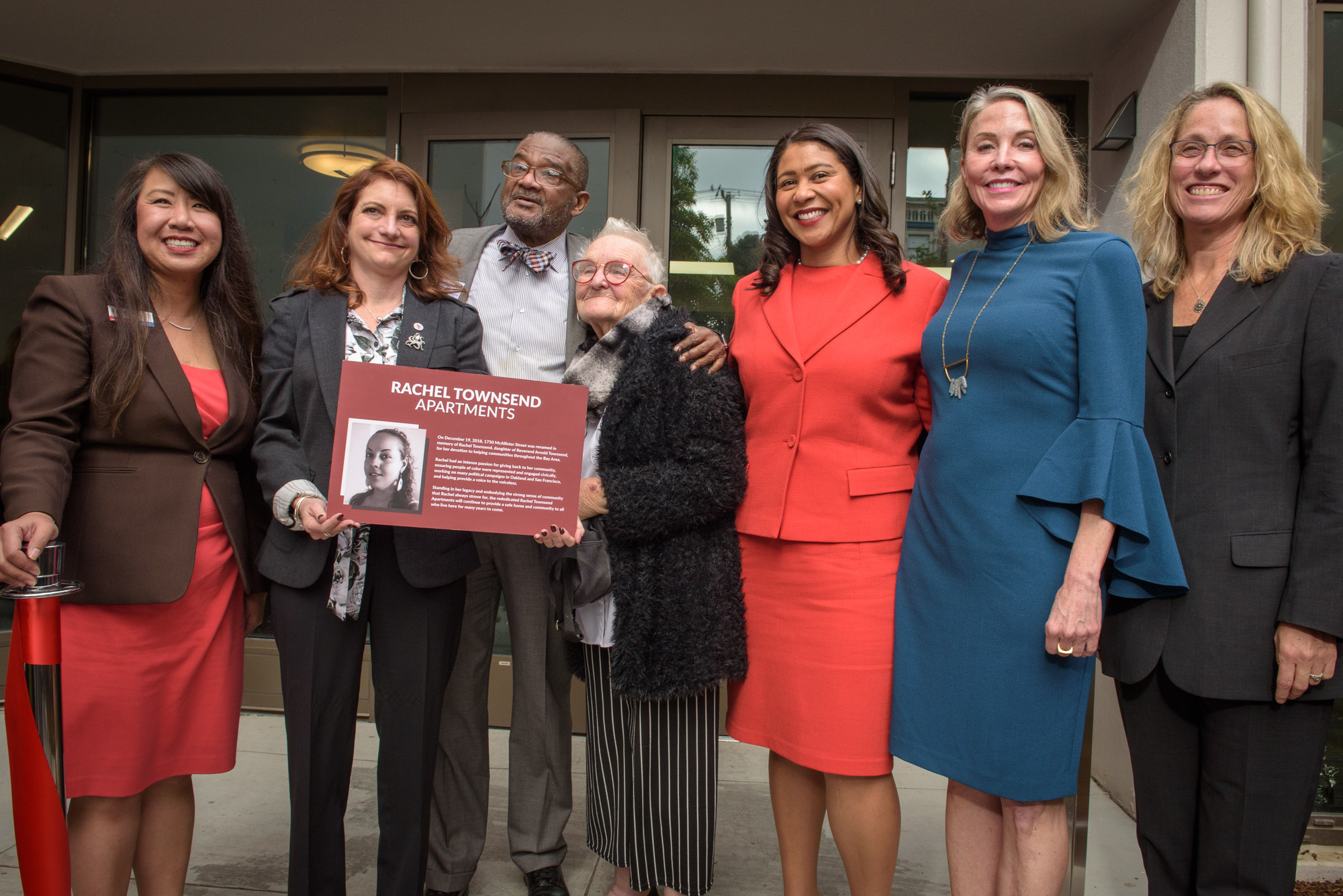 Mayor Breed and Kate Hartley with Supervisor Vallie Brown and community members at the rededication of the Rachel Townsend Apartments